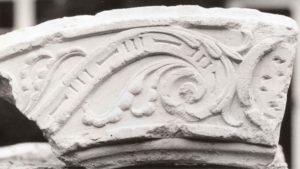 ornately carved piece of stone arch